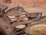 a close up of an old motorcycle with a lot of rust