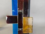 a glass sculpture of a cross made out of glass blocks