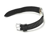 black leather watch strap with silver buckle on a white background