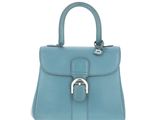 a blue leather handbag with a metal handle on a white background