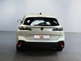 the rear end of a white car in a white room