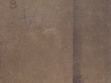 an old book sitting on top of a wooden table covered in writing