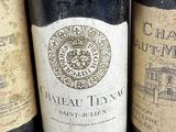 several bottles of wine are lined up on a table