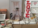 a shelf with candles, candles, and other items on it