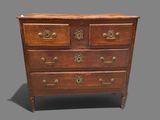 an antique chest of drawers with brass handles on a gray background