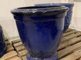 three blue pots sitting on a pallet next to each other