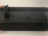 someone is holding a black case that has a black label on it