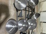 many pots and pans hanging on a rack in a kitchen