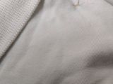 a close up of a white shirt with a hole in it