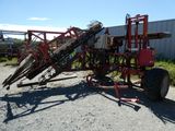 an image of a red tractor with a machine attached to it