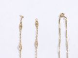three pairs of gold - plated earrings with dangling chains