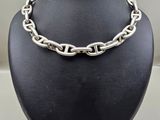 a close up of a necklace on a mannequin display