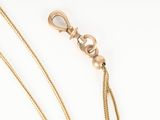 a close up of a gold chain with a clasp on it
