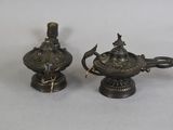 pair of antique brass oil lamps on a white background