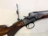 a close up of a rifle on display on a table