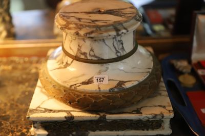 a white and black marble cake on top of a marble block