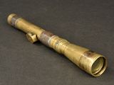 an old brass telescope on a black surface