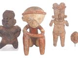 three figurines of different shapes and sizes are displayed on a white surface