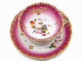 a cup and saucer on a saucer on a white surface