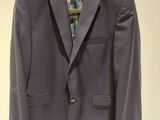 an image of a purple jacket hanging on a hanger
