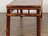 a wooden bench sitting on the floor in a room
