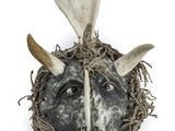 a close up of a mask with horns on a white background