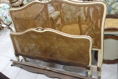a bed with a wooden frame and wicker headboard