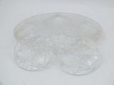 a white plate with four clear plastic plates on it