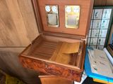a wooden box that has a clock inside of it