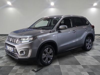 the silver suv is parked on a checkered floor in a garage