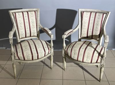 two chairs that are next to each other on a tile floor