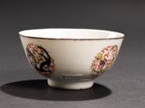 a white bowl with a dragon on it on a table