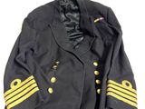 an old black military jacket with gold stripes and buttons