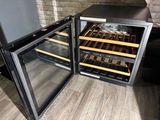 bottles of wine are stored in a wine cooler in a kitchen