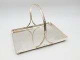 a silver tray with a handle and two rings on it