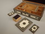 a wooden box with four different items inside of it