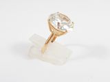 a close up of a gold ring with a white topaz stone
