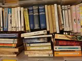 a plastic box filled with books on top of a table