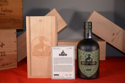 a bottle of wine sitting next to a wooden box