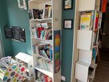 a room with a bookshelf and a chair in it
