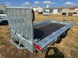 a close up of a flatbed trailer parked in a field