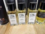 several bottles of different types of perfume sitting on a table