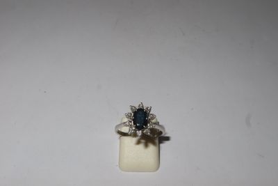 a close up of a ring with a blue stone in it