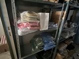 a metal shelf with many items on it in a room