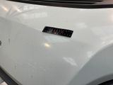 a sticker on the hood of a white car