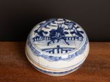 a small blue and white box on a wooden table