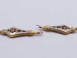 a pair of gold and enamel earrings