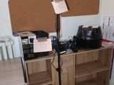 a lamp that is on a stand in the corner of a room
