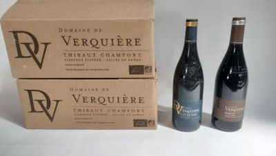 two bottles of wine are sitting next to a box of wine