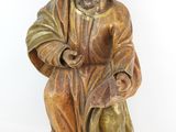 statue d'un homme assis sur un tabouret, tenant un sac
